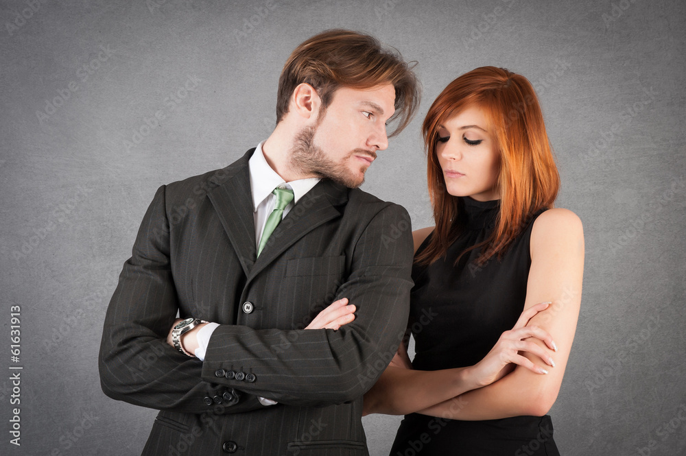 Angry couple studio portrait against grunge background. Angry couple studio portrait against grunge background.