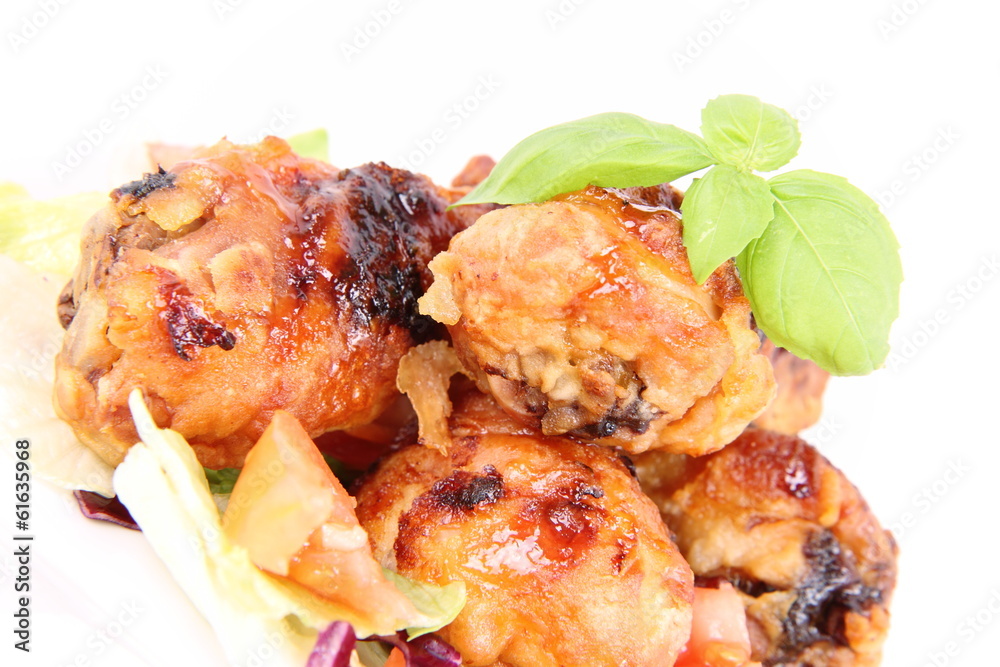 Fried chicken legs with side salad decorated with basil Fried chicken legs with side salad decorated with basil