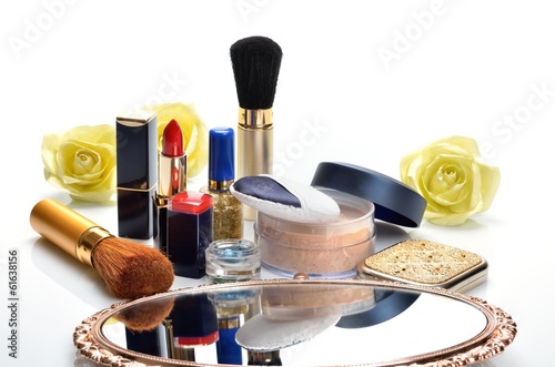 Items for decorative cosmetics, makeup, mirror and flowers