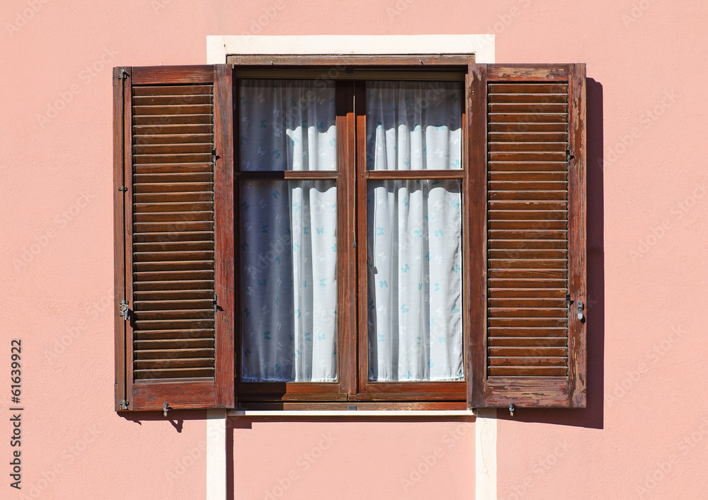 Window with wooden shutters.