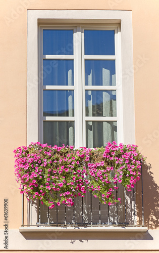 Old italian balcony with flowers.
