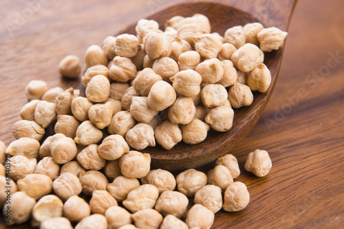 dried white chickpeas ceci on the wooden spoon