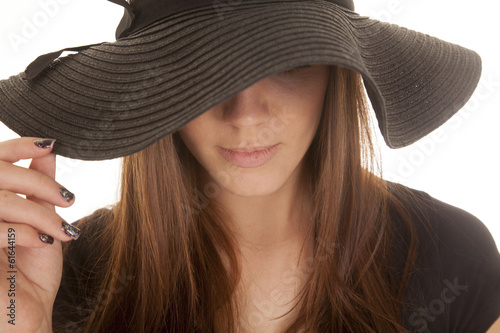 woman black hat touch close up