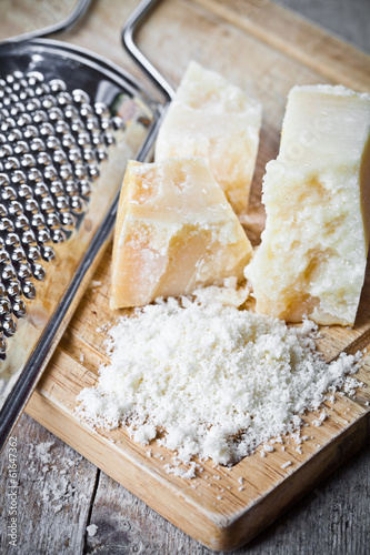 grated parmesan cheese and metal grater photo