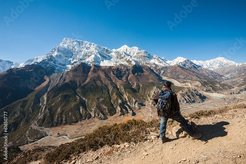 Trekker and Annapurna range, Himalayas of Nepal.