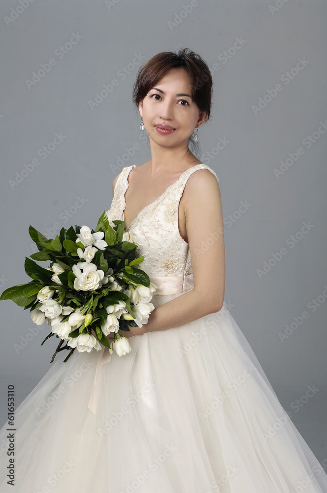 beautiful bride with a bouquet of flowers on gray background beautiful bride with a bouquet of flowers on gray background
