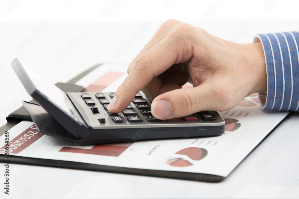 Fototapeta premium Male hand with pen analyzing financial data