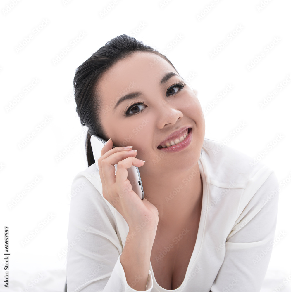 young in casual clothes lying on bed and speaking on the phone young in casual clothes lying on bed and speaking on the phone