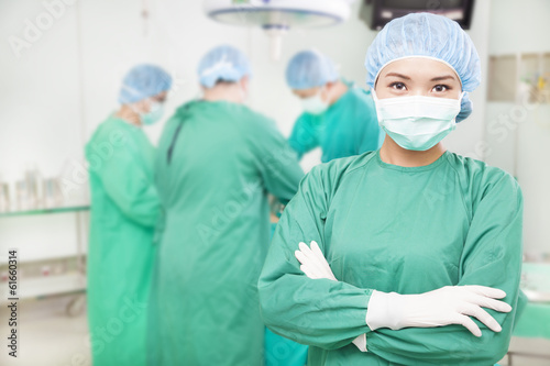 confident female surgeons  crossed hands with  teams