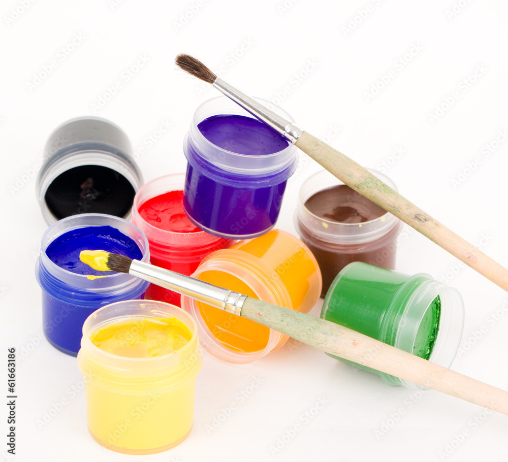 Gouache and brushes isolated on white background