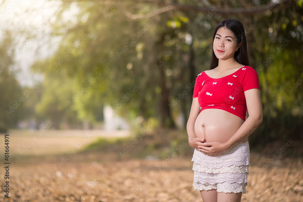 Image of pregnant woman touching her belly with hands