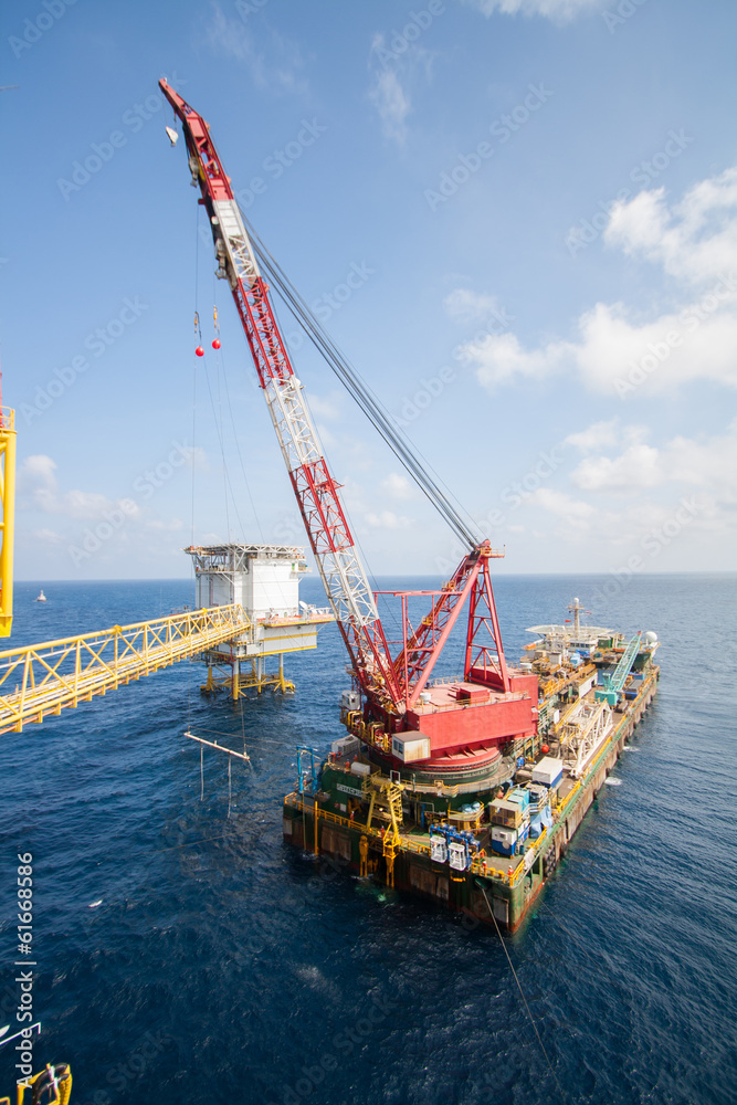 Large crane vessel installing the platform in offshore