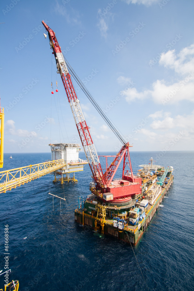 Large crane vessel installing the platform in offshore Large crane vessel installing the platform in offshore