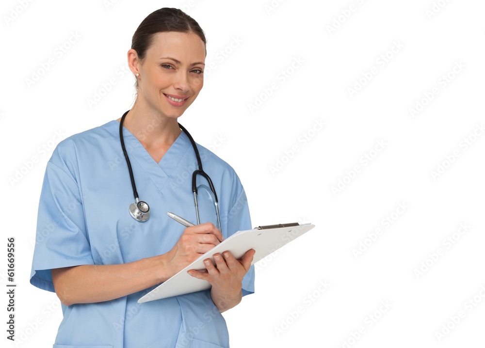 Smiling nurse writing on clipboard Smiling nurse writing on clipboard