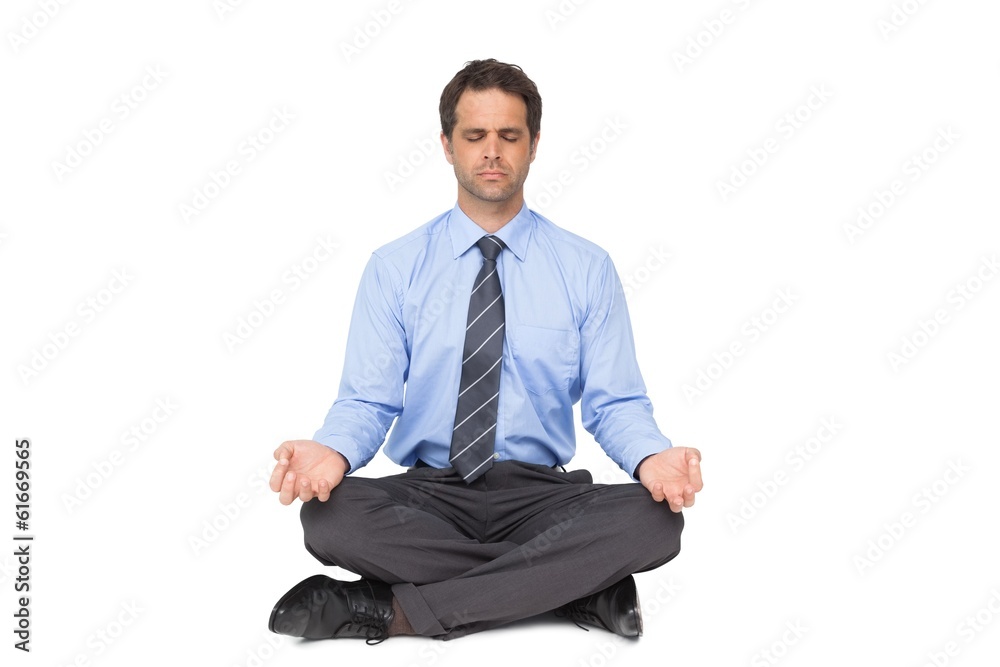 Zen businessman meditating in lotus pose with eyes closed Zen businessman meditating in lotus pose with eyes closed