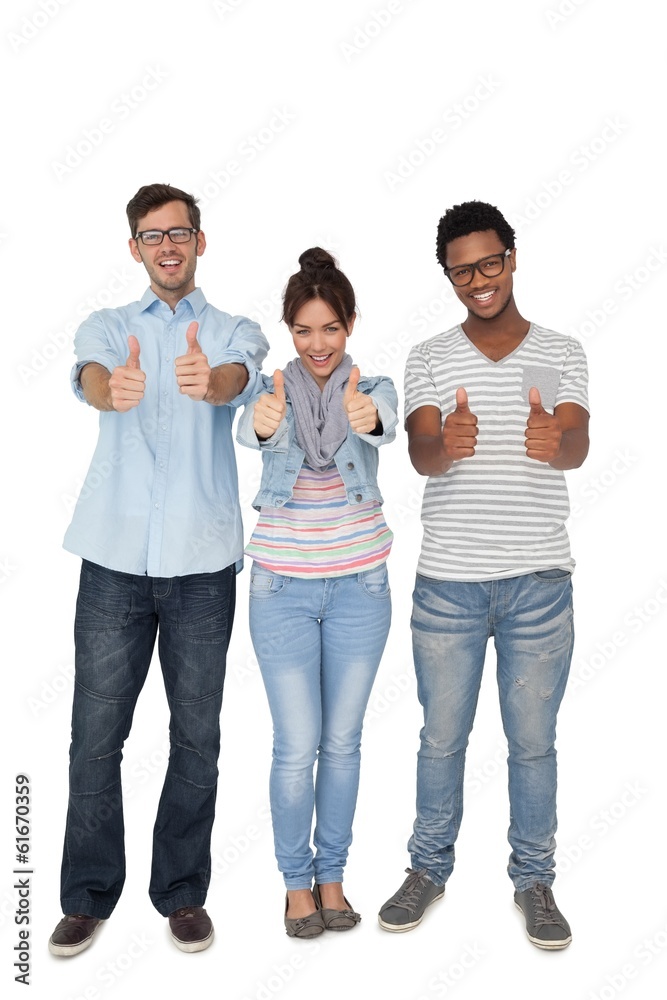 Fototapeta premium Portrait of three happy friends gesturing thumbs up