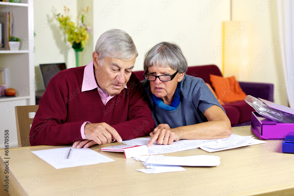 Senior family trying to do financial counts on bills Senior family trying to do financial counts on bills