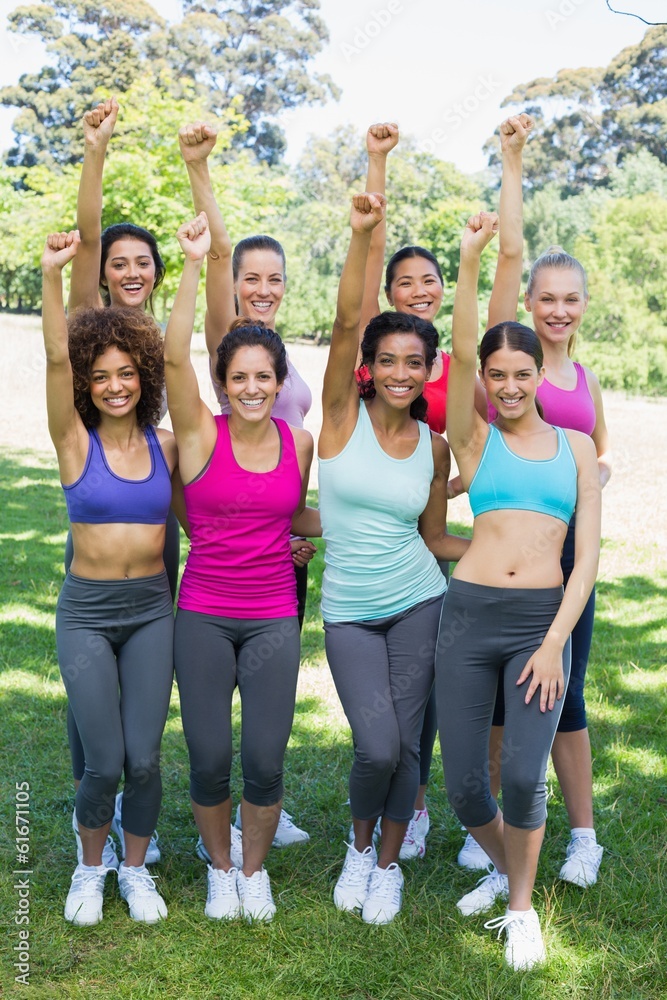 Happy sporty women clenching fist at park Happy sporty women clenching fist at park