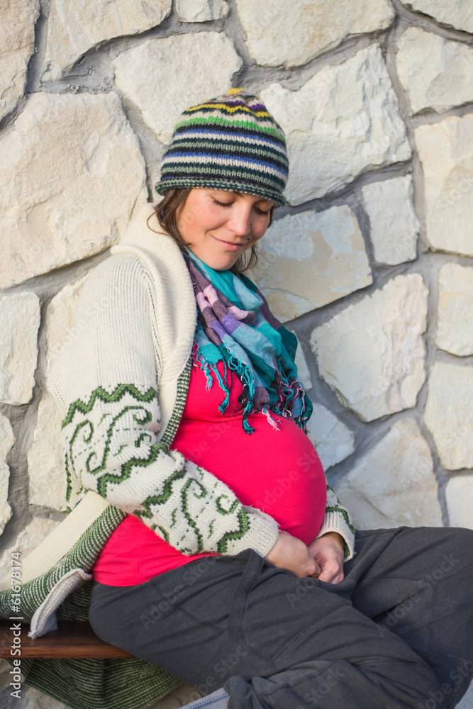 young pregnant women looking down at her belly young pregnant women looking down at her belly