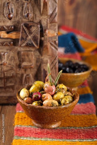 marinated Olives in bowls with morrocan  orament on wood photo