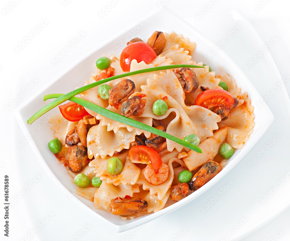 Farfalle pasta with seafood, cherry tomatoes and green peas Farfalle pasta with seafood, cherry tomatoes and green peas