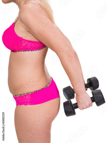 Overweight woman exercising with dumbbells