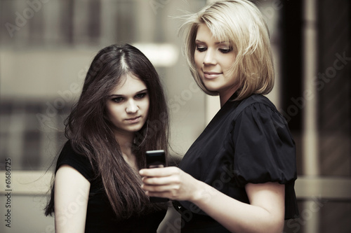 Young women looking at mobile phone