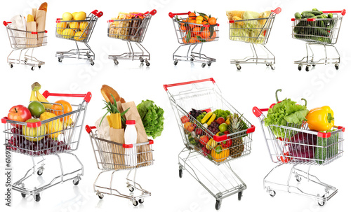 Trolleys with different products isolated on white