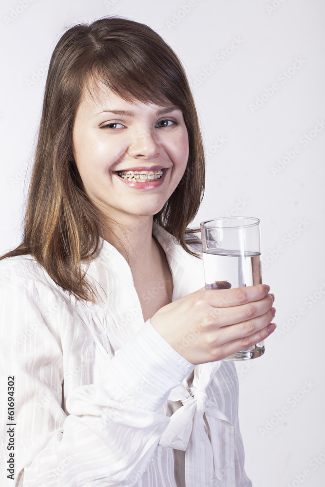 young woman with glass of water on a white young woman with glass of water on a white