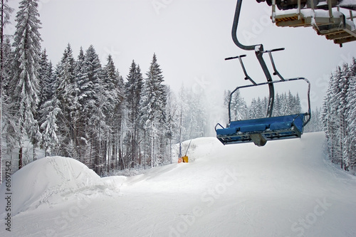 chairlift in snowy forest