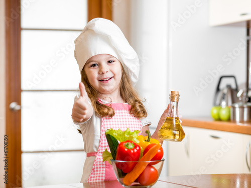 kid girl weared as cook wit...
