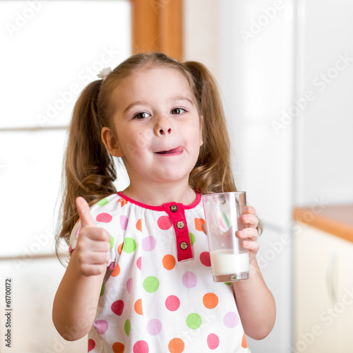 Kid drinking milk from glass