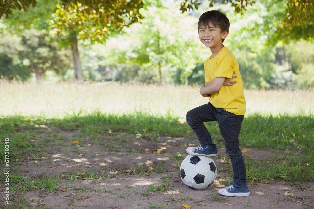 Cute little boy with football at park Cute little boy with football at park