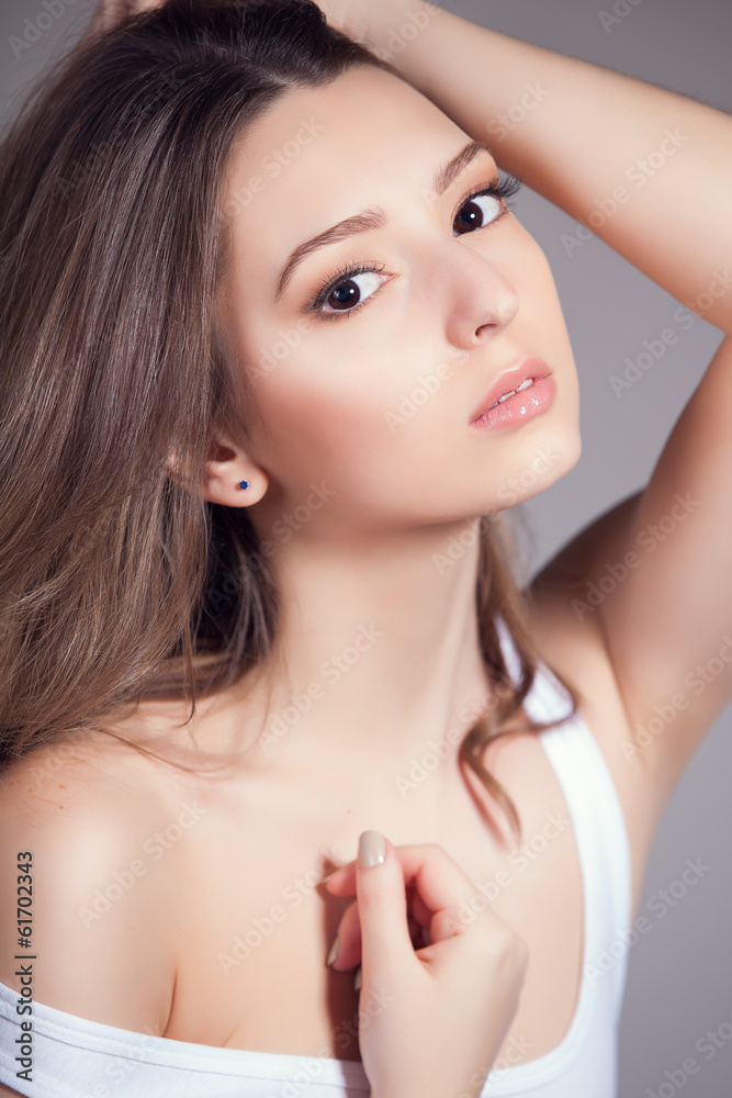 Portrait of beautiful woman over gray background Portrait of beautiful woman over gray background