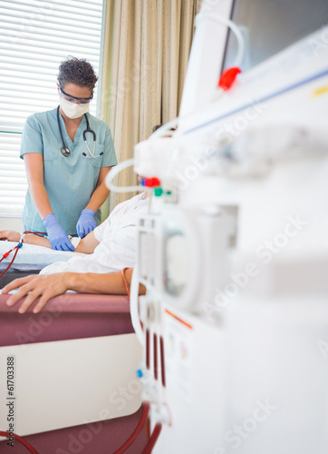 Nurse Giving Renal Dialysis Treatment To Patient