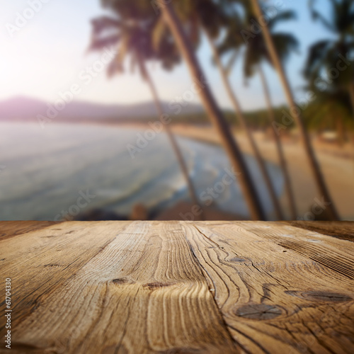 Fototapeta Naklejka Na Ścianę i Meble -  wooden table on the beach with palms