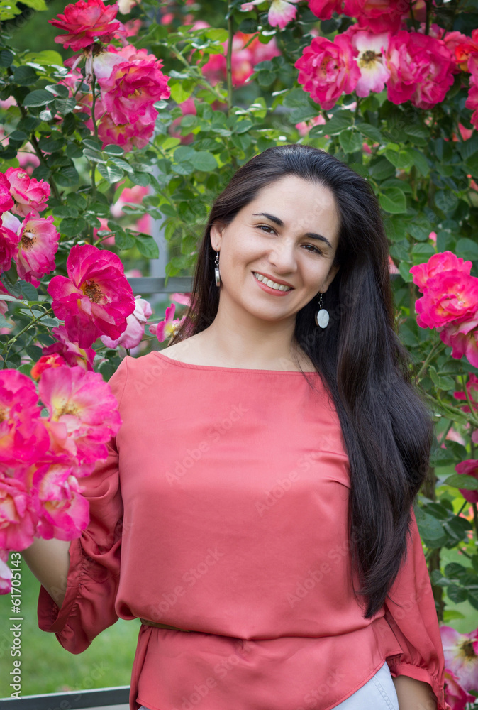The girl smells flavor of roses The girl smells flavor of roses