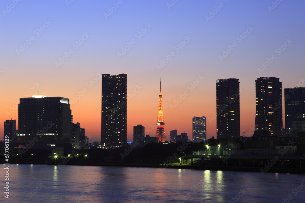 Buildings along Sumida River and evening view of Tokyo Tower