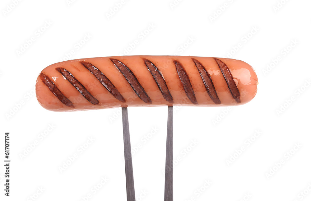 Grilled sausage on a fork. Grilled sausage on a fork.