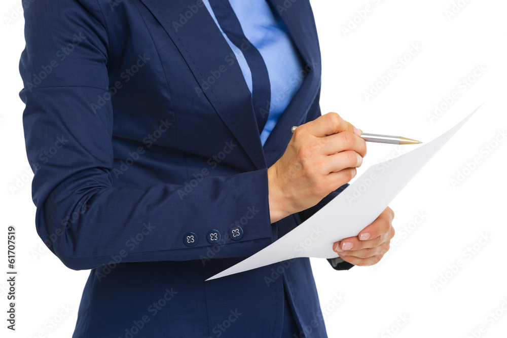 Closeup on business woman examining document Closeup on business woman examining document