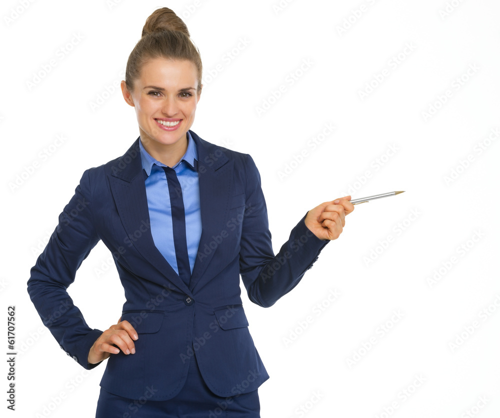 Smiling business woman pointing on copy space with pen Smiling business woman pointing on copy space with pen