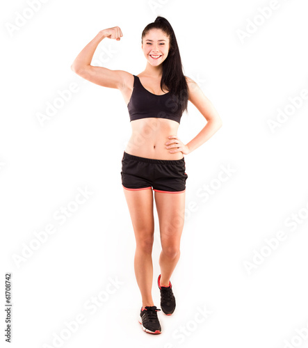 Athletic girl with dumbbells on a white background