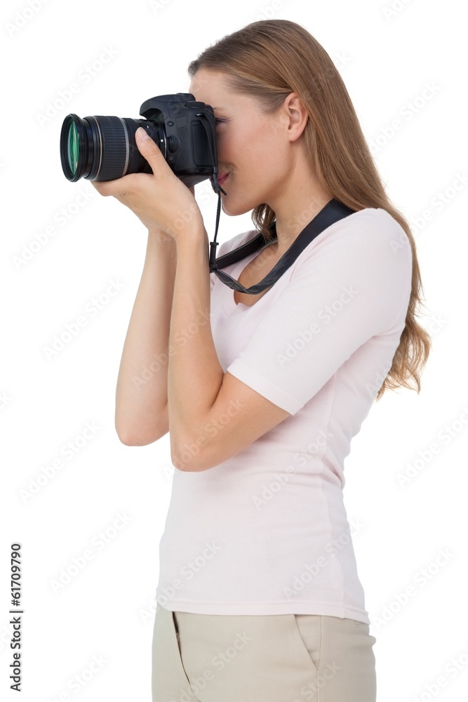 Side view of a young woman with camera