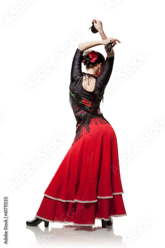 young woman dancing flamenco with castanets isolated on white photo