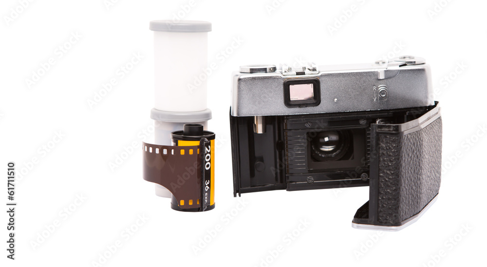 Old retro analog camera with new film roll over white background