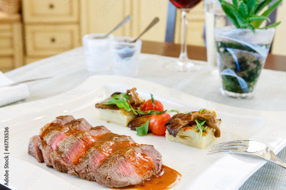 Sliced medium rare roast beef and gravy Sliced medium rare roast beef and gravy