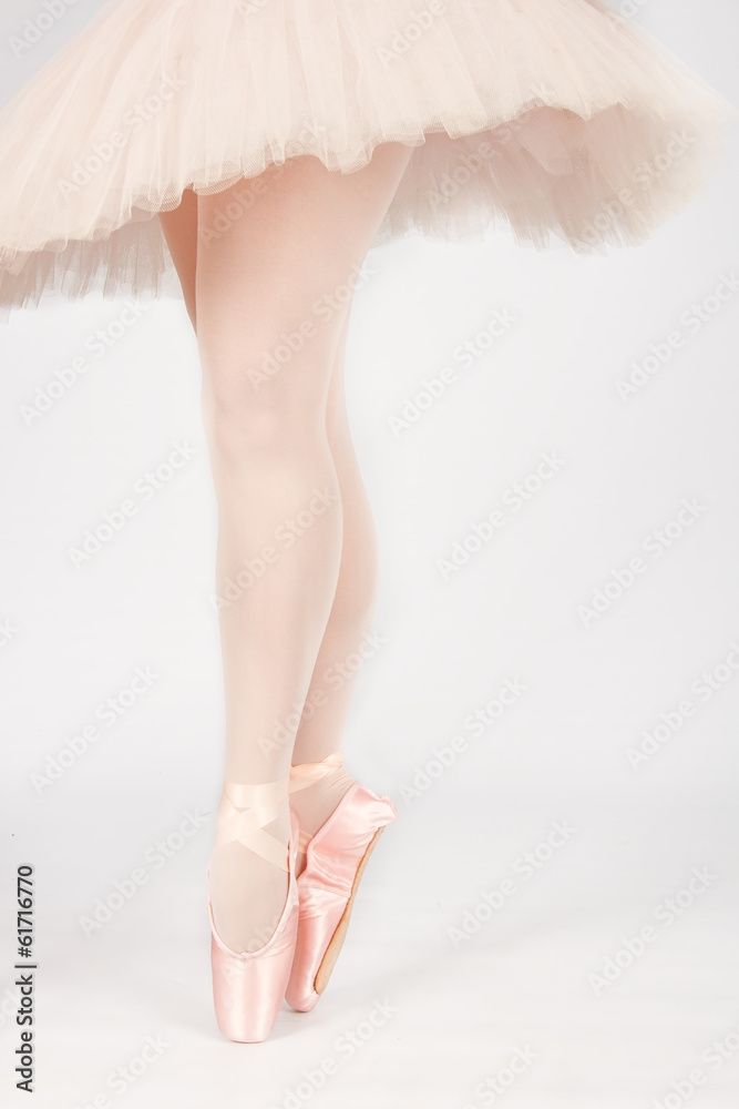 A ballet dancer standing on toes while dancing artistic conversi