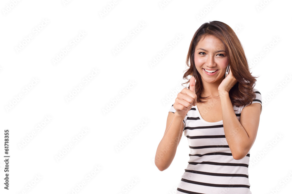 happy, smiling woman giving thumb up with her cellular phone happy, smiling woman giving thumb up with her cellular phone