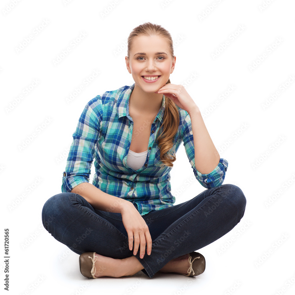 young woman in casual clothes sitting on floor young woman in casual clothes sitting on floor