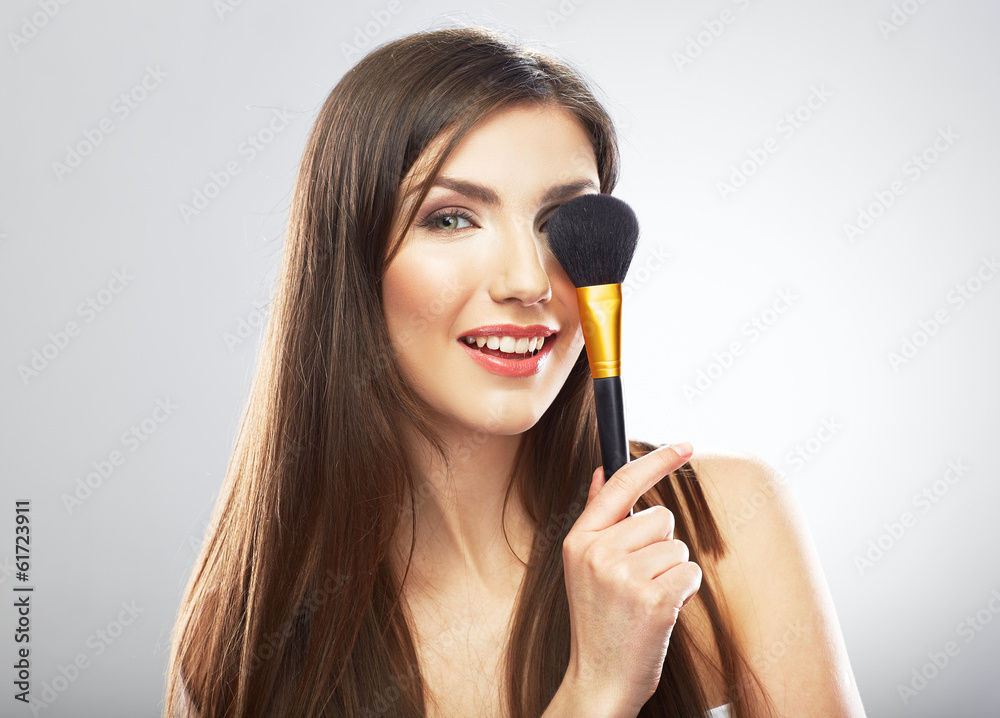 Beauty portrait of young woman holding make up brush. Beauty portrait of young woman holding make up brush.